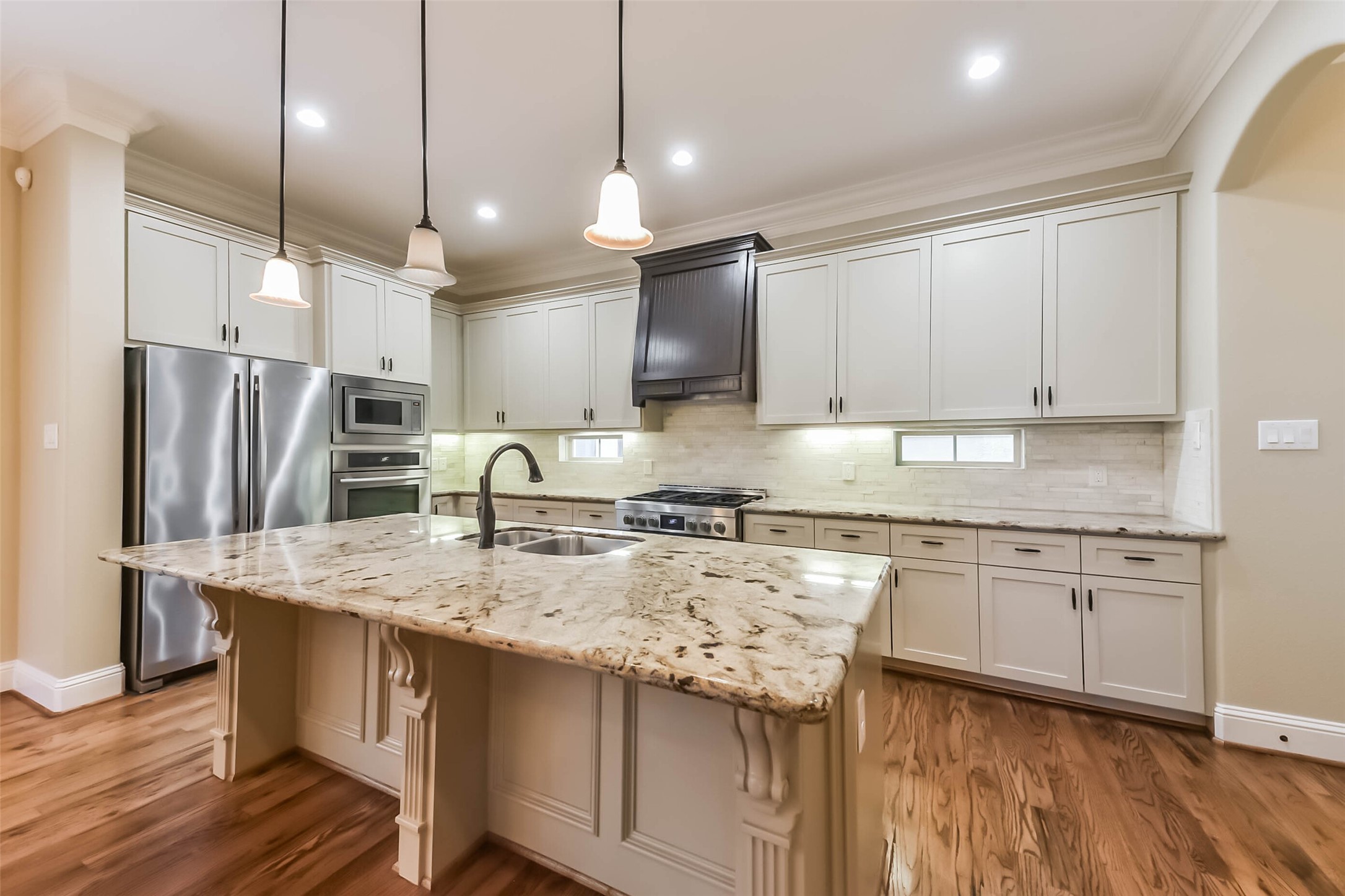 1126 West 16th Street, Unit C Houston, TX 77008 - Photo 19 of 44 a kitchen with stainless steel appliances granite countertop a sink refrigerator and cabinets