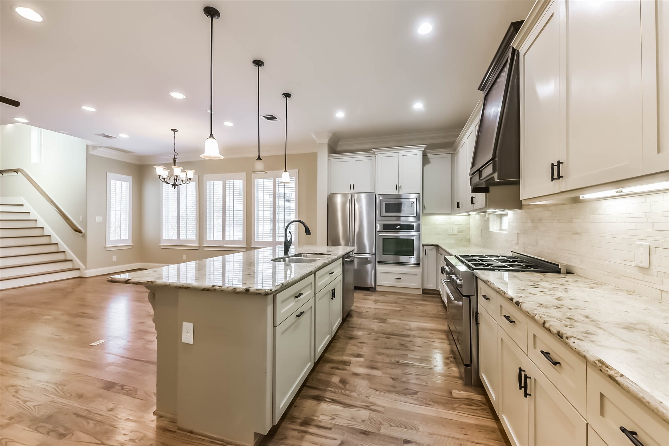 1126 West 16th Street, Unit C Houston, TX 77008 - Photo 20 of 44 a large kitchen with stainless steel appliances granite countertop plenty wooden cabinets counter space a sink and a wooden floor