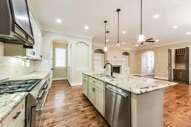 a kitchen with granite countertop stainless steel appliances and wooden cabinets