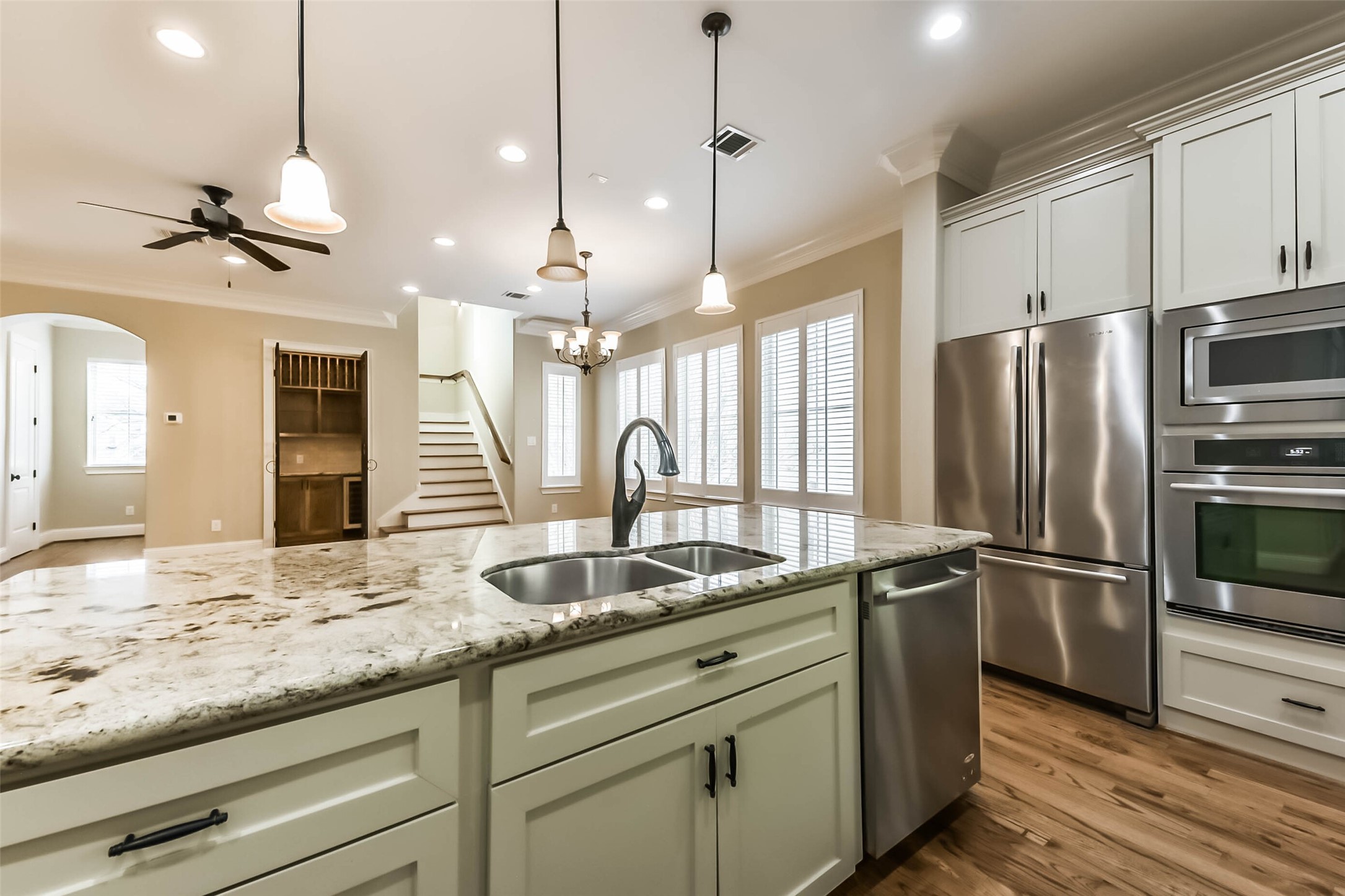 1126 West 16th Street, Unit C Houston, TX 77008 - Photo 22 of 44 a kitchen with kitchen island granite countertop a center island a sink appliances and cabinets