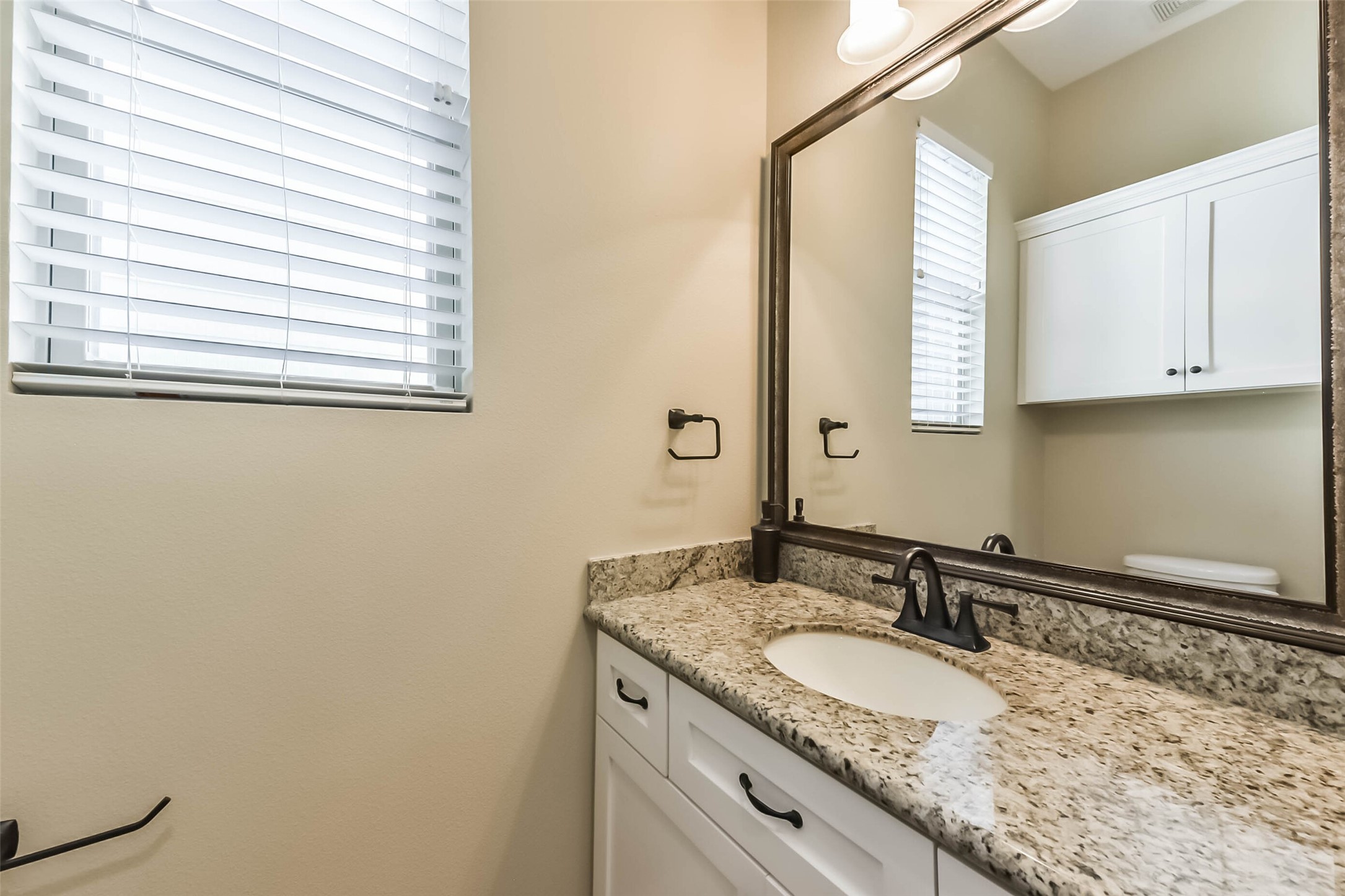 1126 West 16th Street, Unit C Houston, TX 77008 - Photo 25 of 44 a bathroom with a granite countertop sink and a mirror