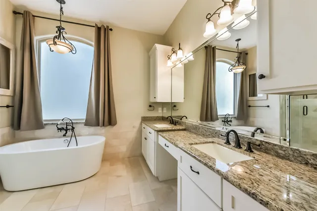 a bathroom with a granite countertop shower