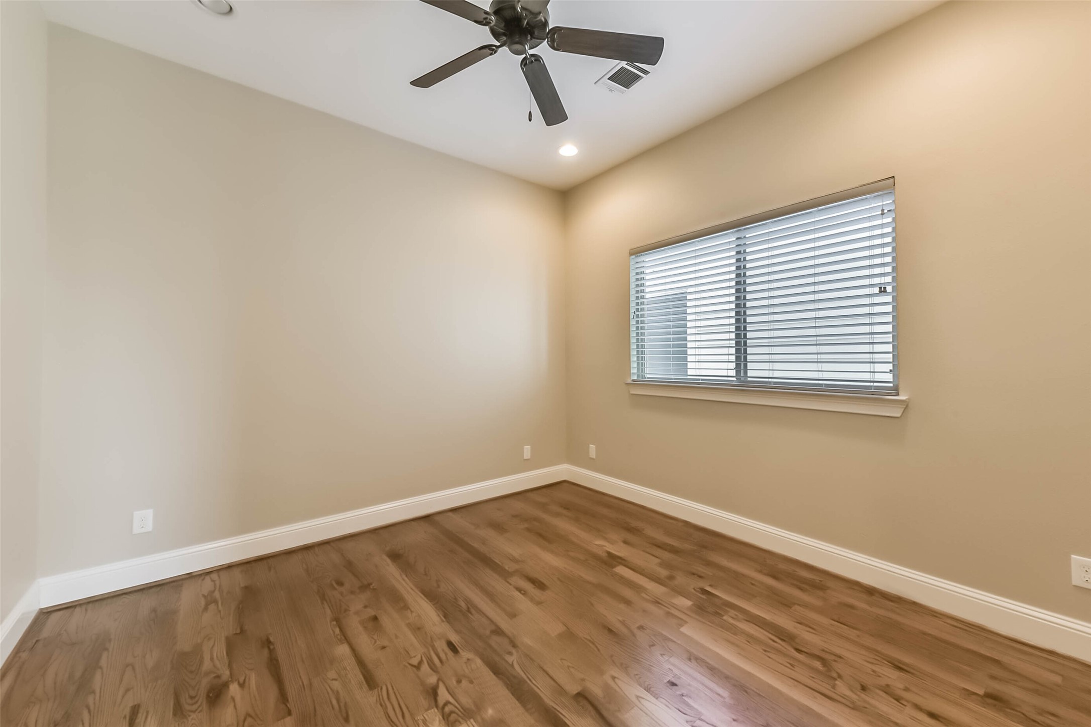 1126 West 16th Street, Unit C Houston, TX 77008 - Photo 34 of 44 a view of a room with wooden floor and a ceiling fan