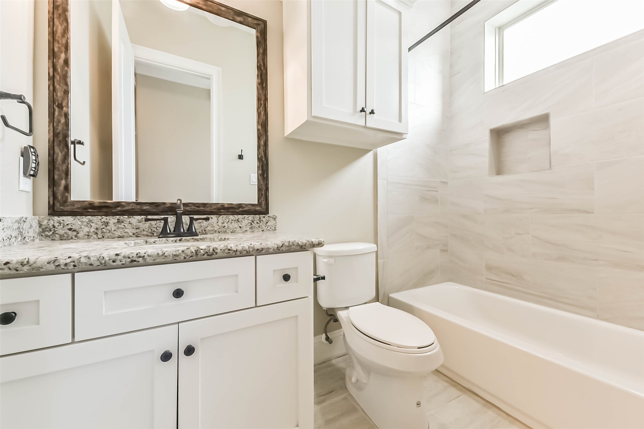 1126 West 16th Street, Unit C Houston, TX 77008 - Photo 36 of 44 a bathroom with a granite countertop toilet sink and mirror