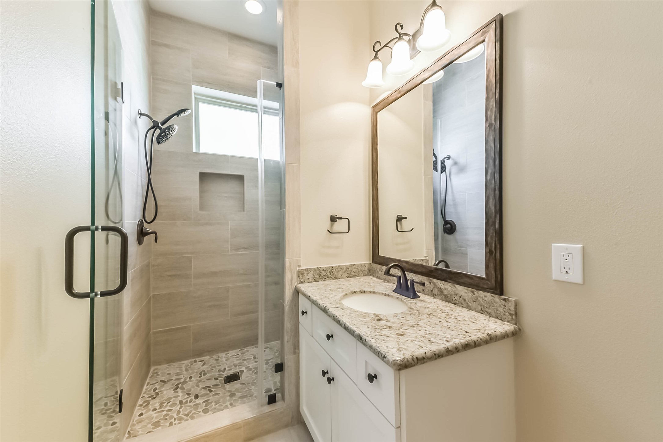 1126 West 16th Street, Unit C Houston, TX 77008 - Photo 10 of 44 a bathroom with a granite countertop sink a mirror and shower