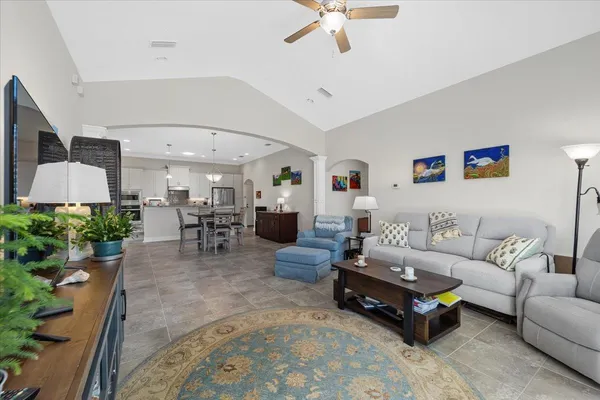 a living room with furniture and a chandelier