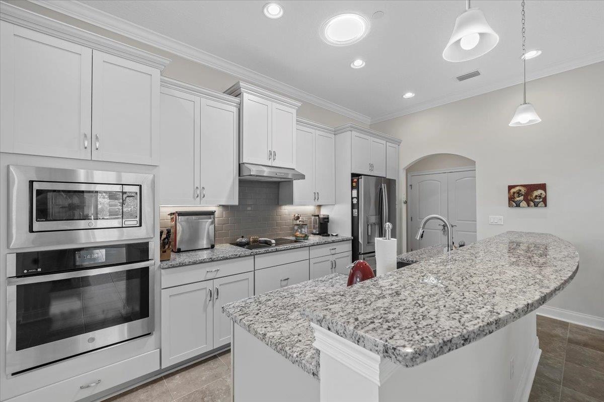 35 Timoga Trail St. Augustine, FL 32084 - Photo 18 of 52 a kitchen with stainless steel appliances granite countertop a sink stove and cabinets
