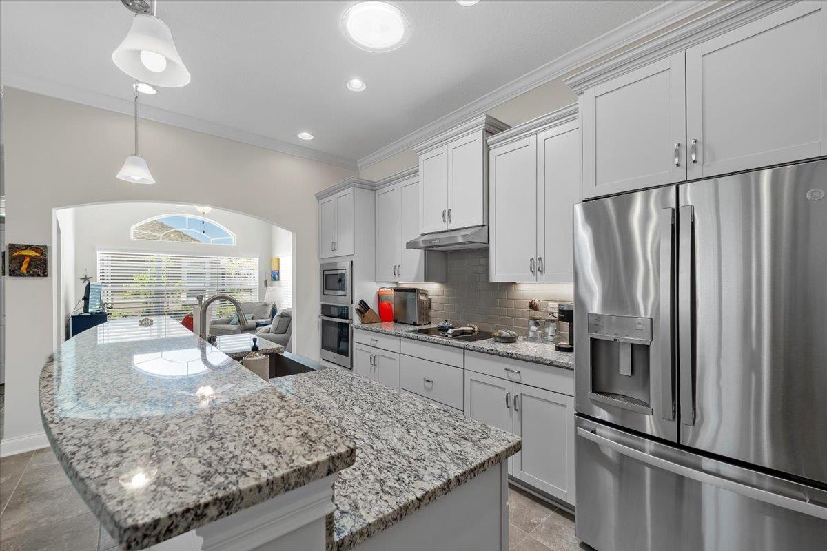 35 Timoga Trail St. Augustine, FL 32084 - Photo 19 of 52 a kitchen with stainless steel appliances granite countertop a sink refrigerator and microwave
