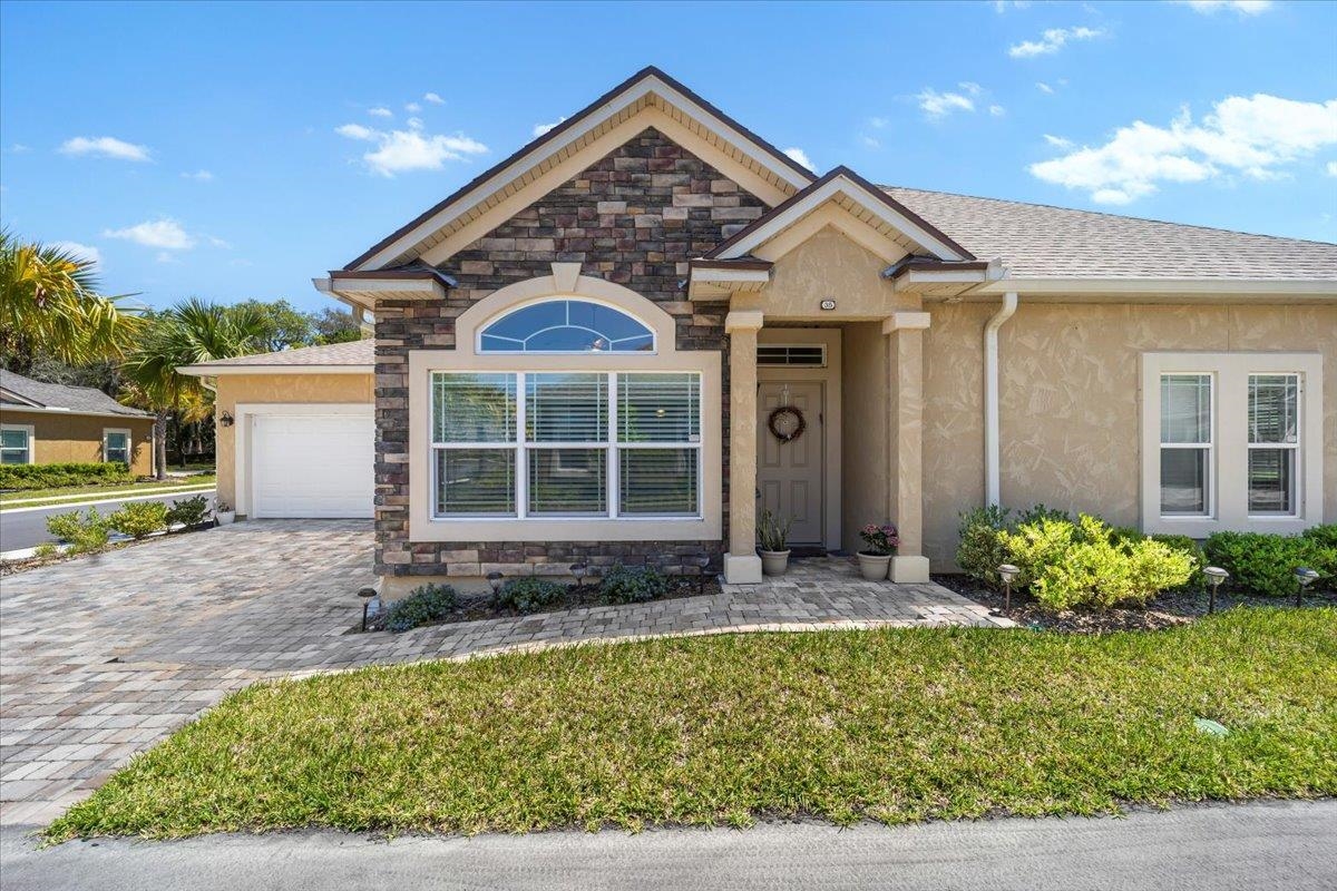 35 Timoga Trail St. Augustine, FL 32084 - Photo 2 of 52 a front view of a house with a yard and garage
