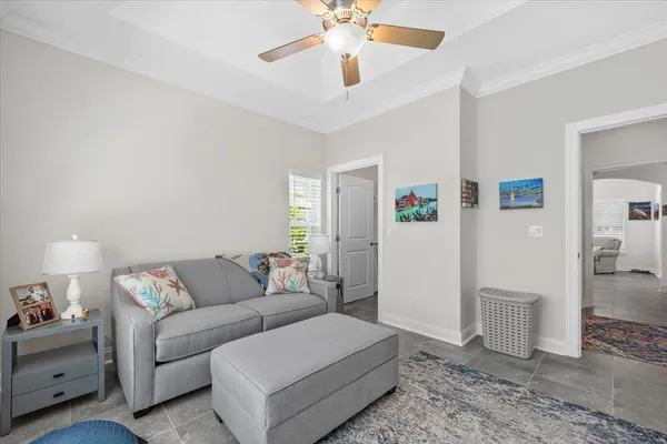 a living room with furniture a bed and a window