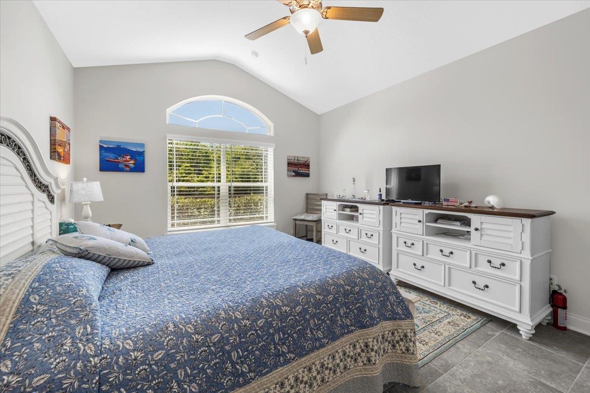 35 Timoga Trail St. Augustine, FL 32084 - Photo 27 of 52 a spacious bedroom with a bed and a chandelier