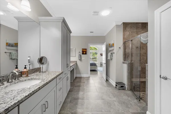 a bathroom with a shower and a sink