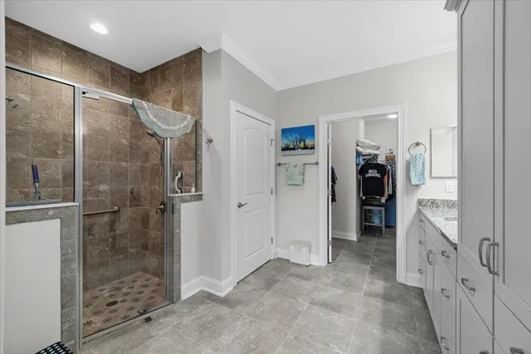 a bathroom with a granite countertop sink a toilet a mirror and bathtub