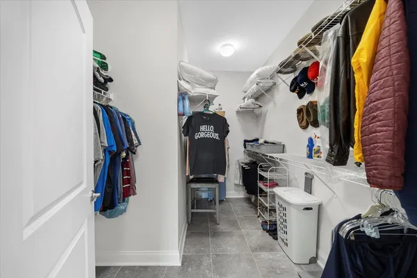 a bathroom with a granite countertop toilet a sink and a mirror