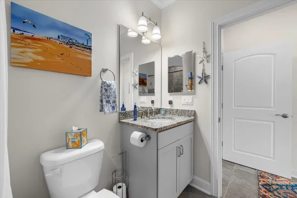 a kitchen with stainless steel appliances granite countertop a shelf and a refrigerator