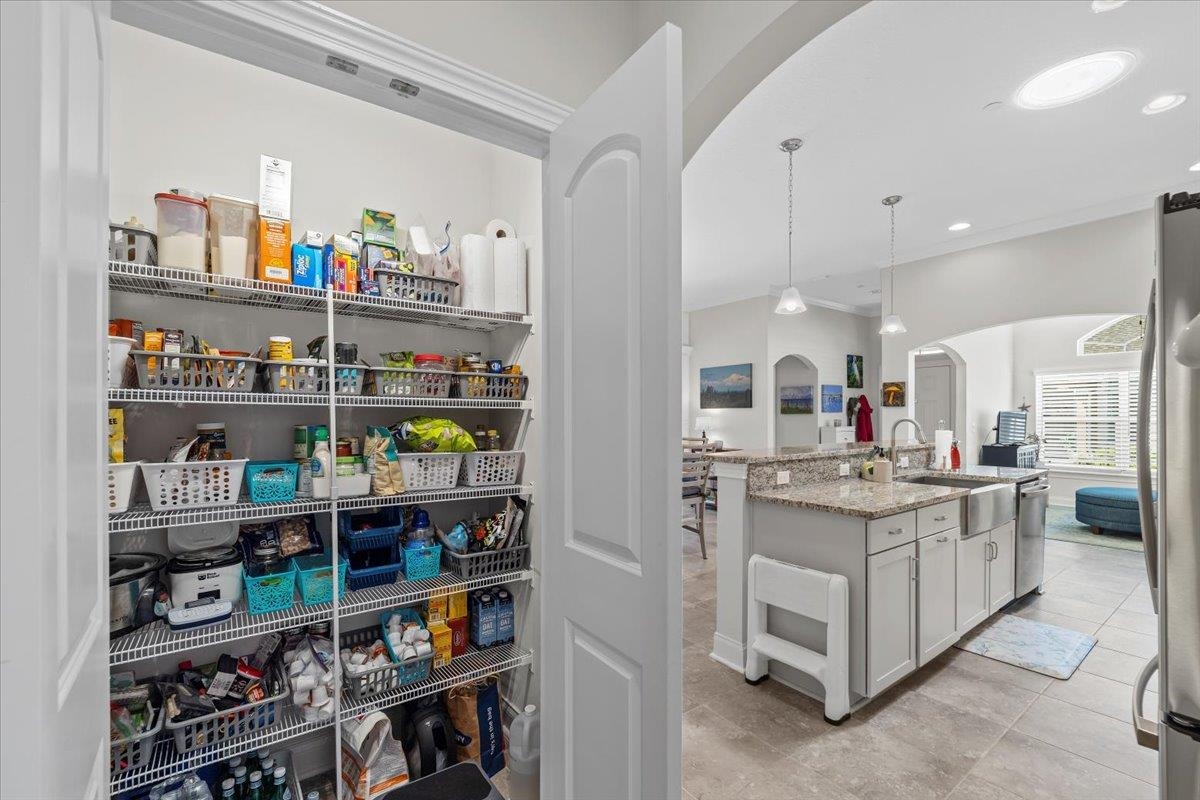 35 Timoga Trail St. Augustine, FL 32084 - Photo 40 of 52 a kitchen with stainless steel appliances granite countertop a shelf and a refrigerator