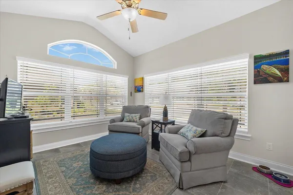 a living room with furniture and a large window