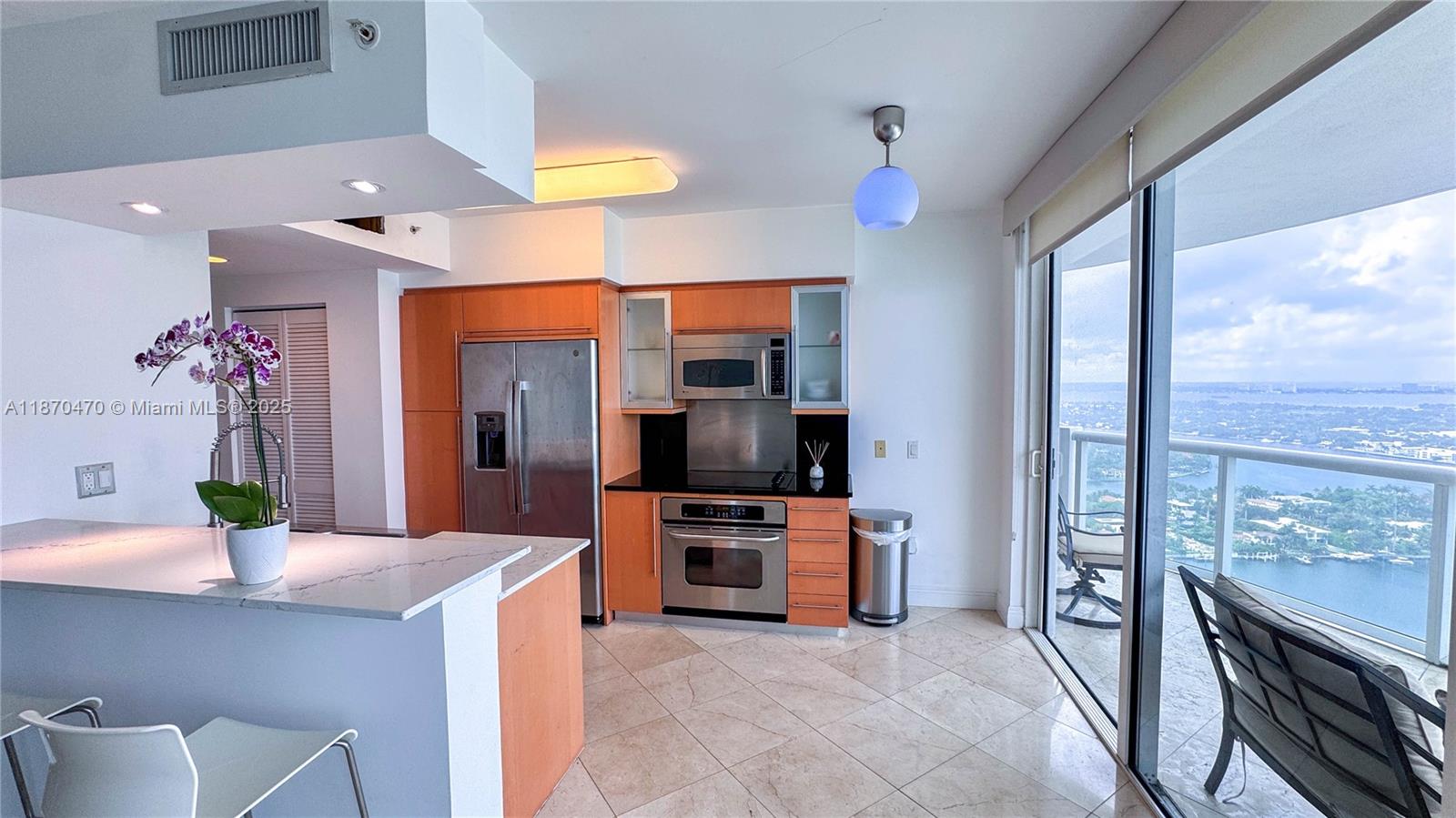 6365 Collins Avenue, Unit 3811 Miami Beach, FL 33141 - Photo 8 of 45 kitchen with balcony access