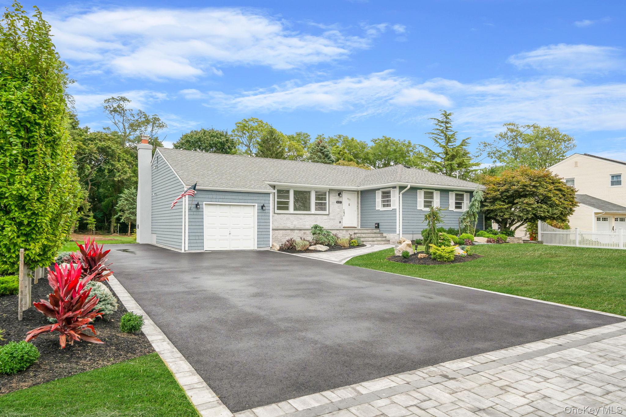 827 Aberdeen Road Bay Shore, NY 11706 - Photo 2 of 40 a front view of a house with a yard and garage