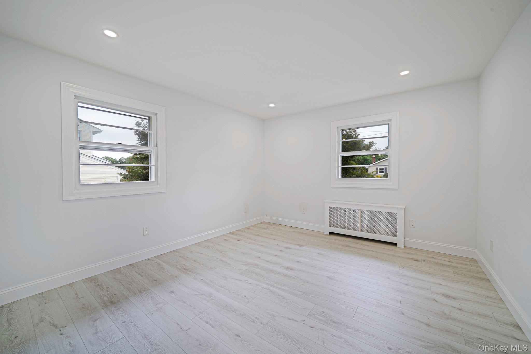 827 Aberdeen Road Bay Shore, NY 11706 - Photo 25 of 40 a view of empty room with wooden floor and fan