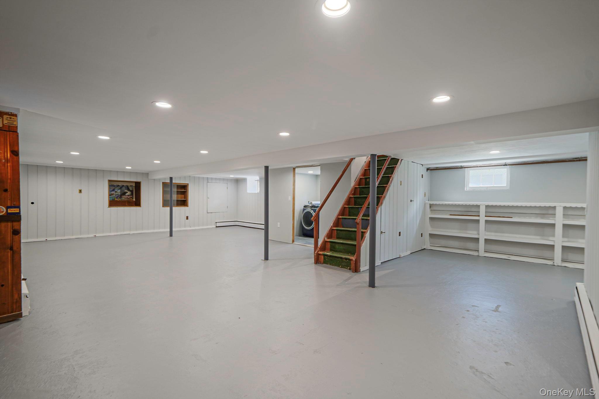827 Aberdeen Road Bay Shore, NY 11706 - Photo 29 of 40 an empty room with wooden floor and stairs