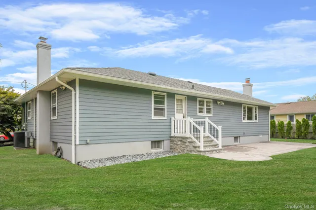 a front view of house with yard and outdoor seating