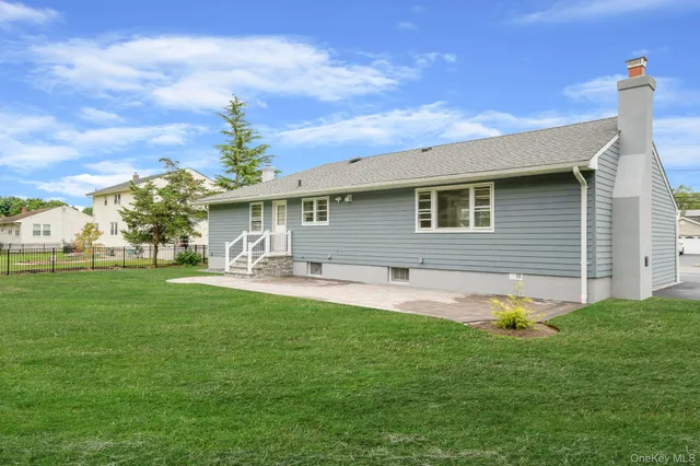 a front view of house with yard and seating area