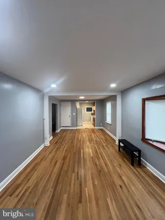 a big room with wooden floor and window