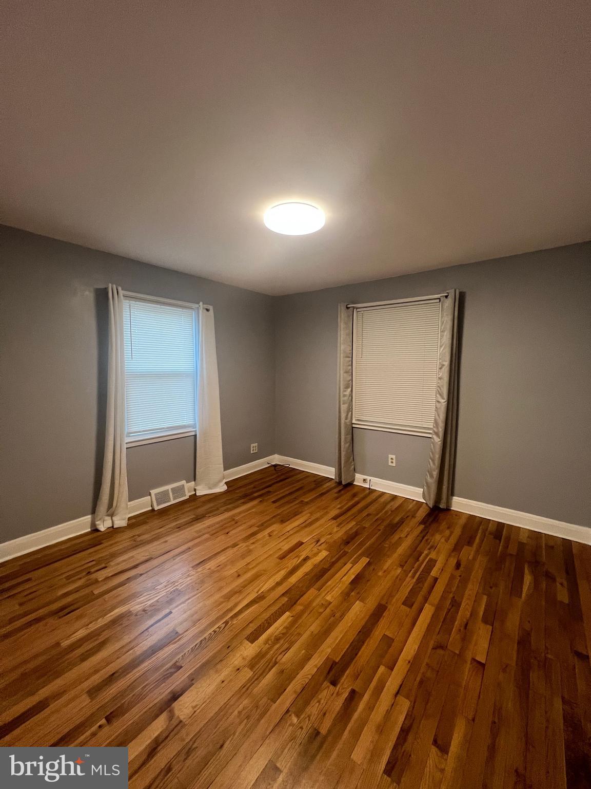 2518 Linwood Road Parkville, MD 21234 - Photo 9 of 27 a view of an empty room with wooden floor and a window