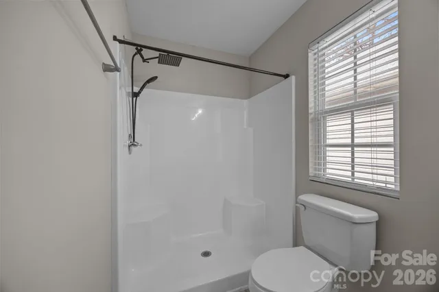 a white toilet sitting next to a bathroom sink