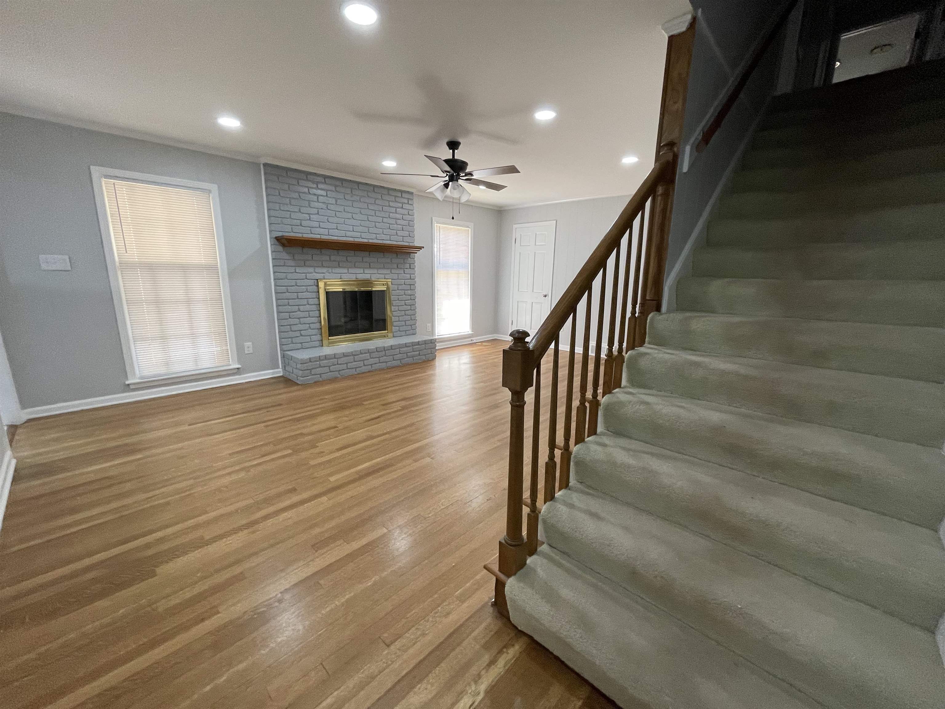 379 McElroy Road Memphis, TN 38120 - Photo 18 of 22 Living area featuring a painted brick fireplace with a wood mantel, wood-finish flooring, and recessed lighting