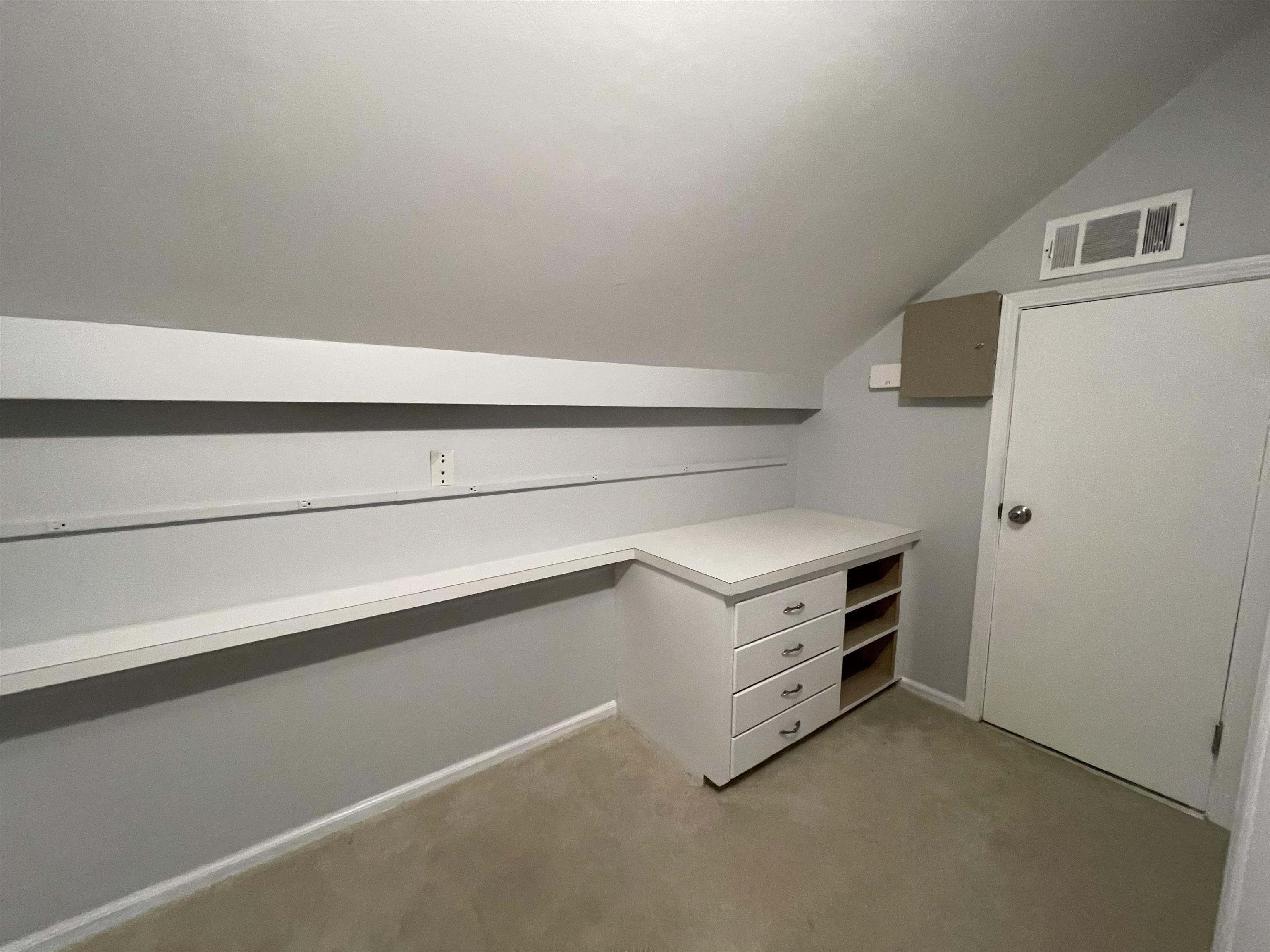 379 McElroy Road Memphis, TN 38120 - Photo 20 of 22 Built-in desk with drawers and shelving, complemented by a long wall shelf