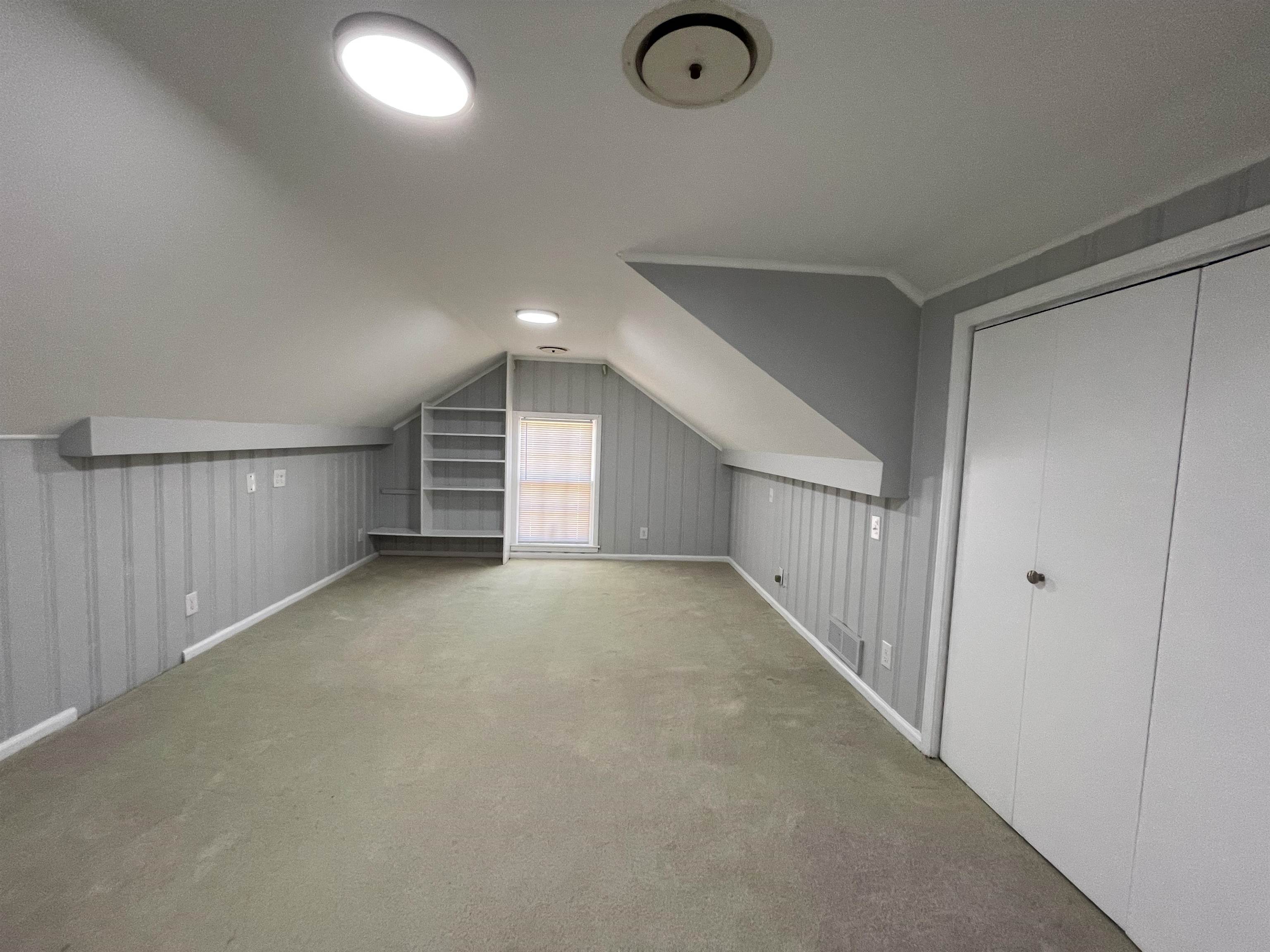 379 McElroy Road Memphis, TN 38120 - Photo 21 of 22 Carpeted room featuring sloped ceilings, beadboard paneling, recessed lighting, built-in shelving, and a window with blinds
