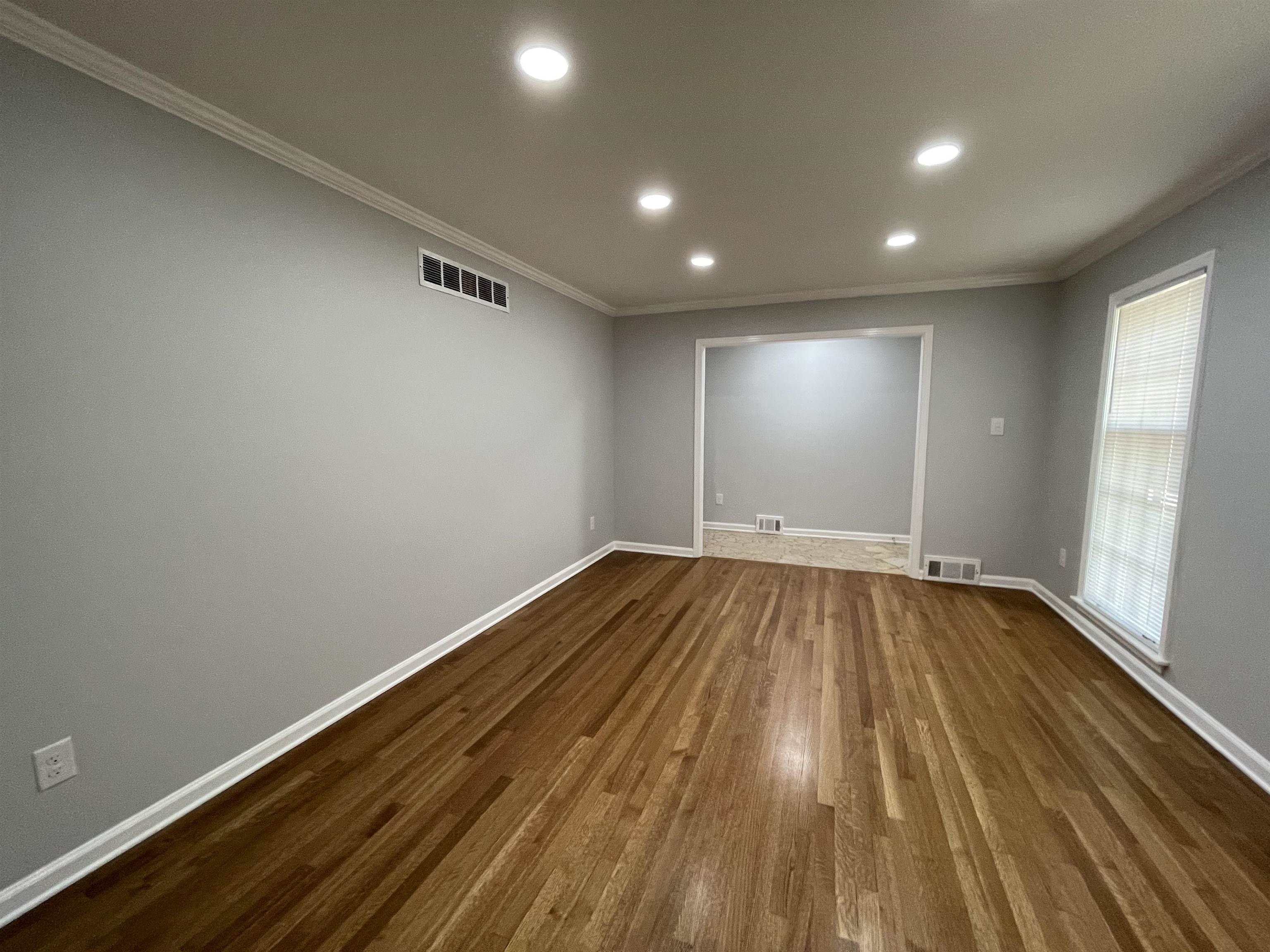 379 McElroy Road Memphis, TN 38120 - Photo 9 of 22 Room featuring wood-finish flooring, recessed ceiling lighting, and crown molding