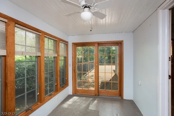 a view of an empty room with cabinet and floor to ceiling window