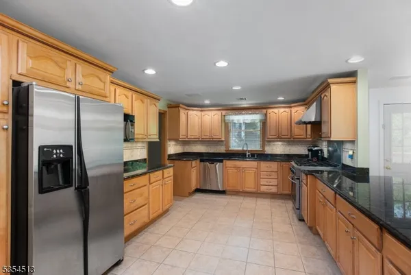 a large kitchen with stainless steel appliances lots of counter top space