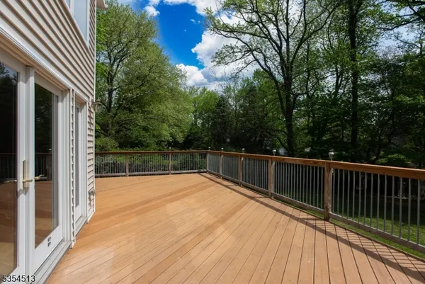a view of balcony with wooden floor and fence