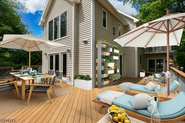 a view of a patio with table and chairs under an umbrella