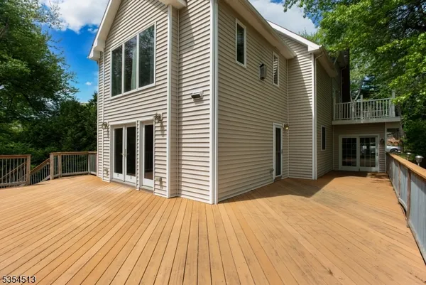 a view of backyard with barbeque oven and wooden fence