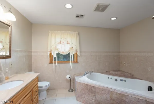 a bath room with a toilet a sink and a bath tub