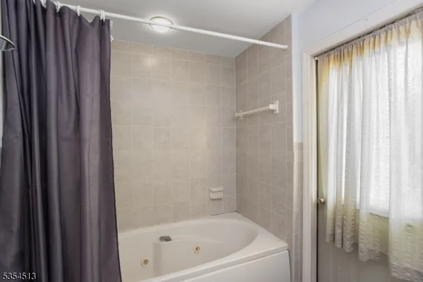 a bathroom with a bathtub and shower