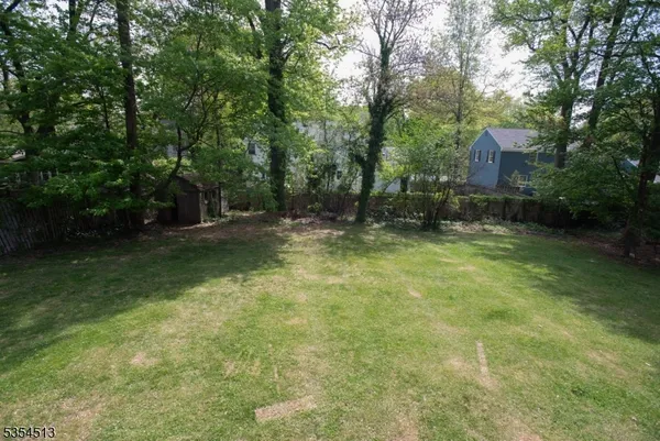 a backyard of a house with lots of green space and fountain