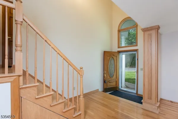 a view of front door with hallway and stairs