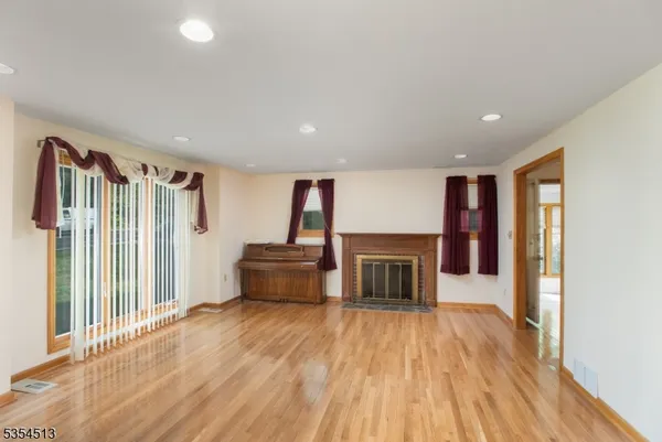 a view of livingroom with hardwood floor and fireplace