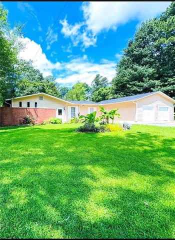 a view of yard with swimming pool and green space