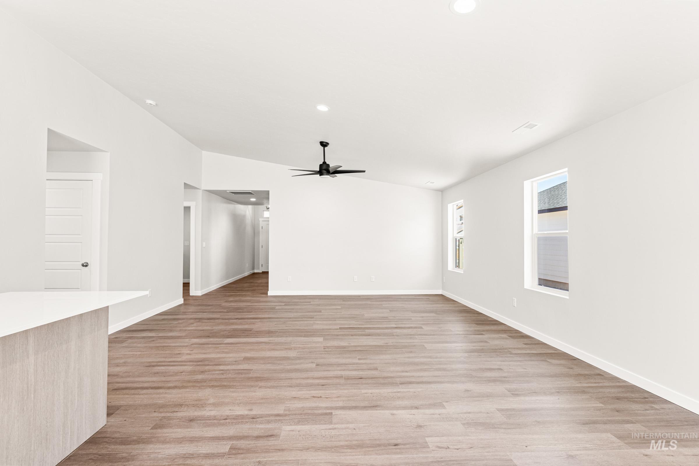1077 West Jasper Street Meridian, ID 83642 - Photo 8 of 19 Spacious living area featuring wood-finish flooring, vaulted ceilings, and recessed lighting