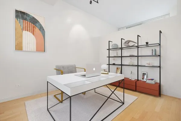 a view of a workspace with furniture