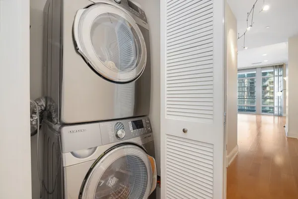 a view of a hallway with washer and dryer