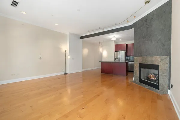 a view of empty room with a fireplace