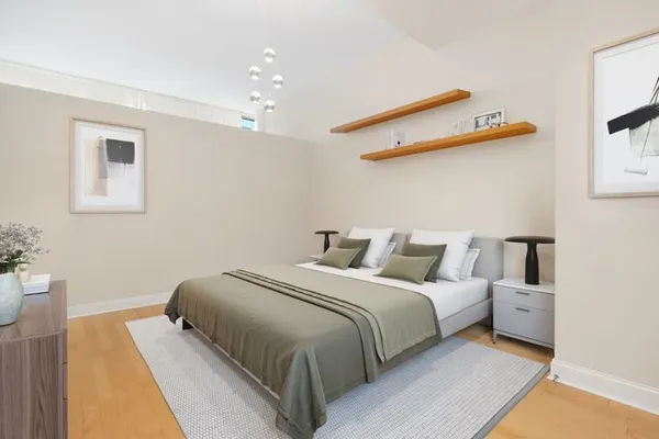a bedroom with a bed and a night stand